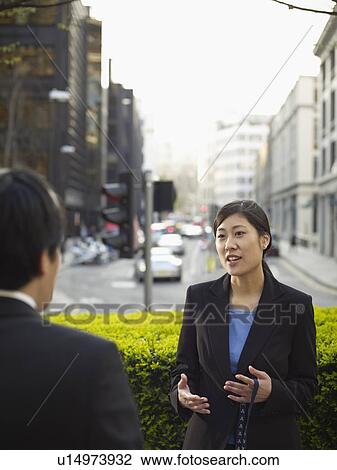 Business people talking on city street View Large Photo Image Stock Image - Business people talking on city street. Fotosearch