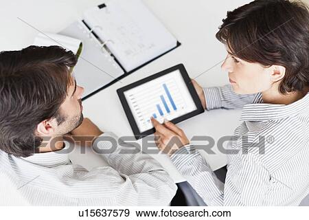 Business people using tablet computer View Large Photo Image Stock Photo - Business people using tablet computer. Fotosearch