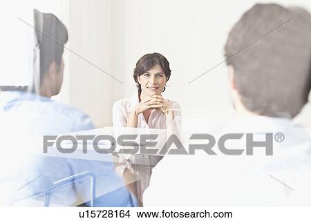 Picture - Business people viewed through window. Fotosearch