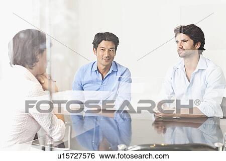 Stock Photograph - Business people viewed through window. Fotosearch