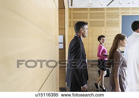 Business people walking into conference View Large Photo Image Stock Photography - Business people walking into conference. Fotosearch
