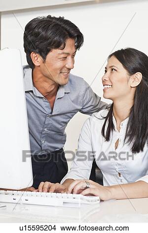 Business people working together at desk View Large Photo Image Picture - Business people working together at desk. Fotosearch