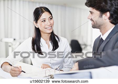 Stock Photo - Business people working together. Fotosearch