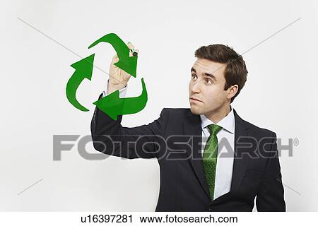 Stock Image - Businessman drawing recycle symbol in air. Fotosearch