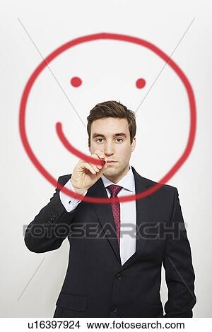 Picture - Businessman drawing smiley face in air. Fotosearch