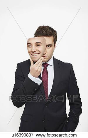 Download Businessman Holding Mask Over His Face Stock Photo U16390837 Fotosearch PSD Mockup Templates