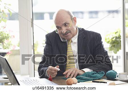 Businessman painting his nails at desk View Large Photo Image Stock Photography - Businessman painting his nails at desk. Fotosearch
