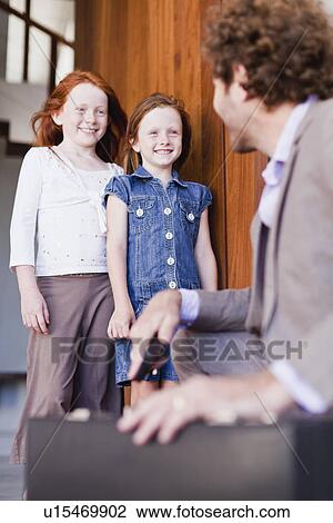 Businessman saying goodbye to daughters View Large Photo Image Stock Image - Businessman saying goodbye to daughters. Fotosearch