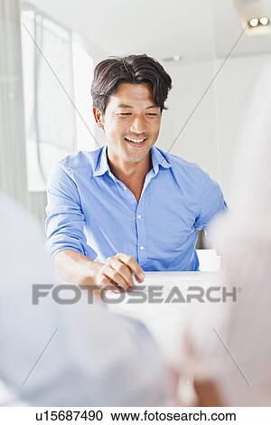 Businessman sitting in meeting View Large Photo Image Stock Image - Businessman sitting in meeting. Fotosearch
