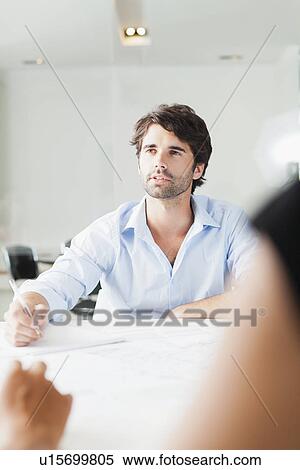 Stock Photography - Businessman sitting in meeting. Fotosearch