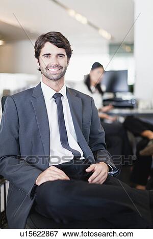 Stock Photo - Businessman smiling in office. Fotosearch