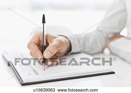 Businessman taking notes at desk View Large Photo Image Stock Image - Businessman taking notes at desk. Fotosearch
