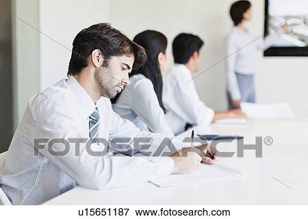 Stock Photo - Businessman taking notes in meeting. Fotosearch