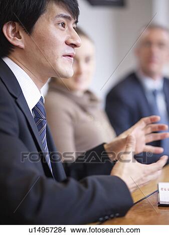 Businessman talking in office View Large Photo Image Picture - Businessman talking in office. Fotosearch