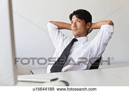 Businessman thinking at his desk View Large Photo Image Stock Photo - Businessman thinking at his desk. Fotosearch
