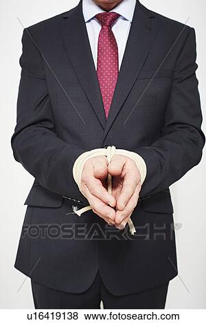 Businessman with hands tied View Large Photo Image Stock Photo - Businessman with hands tied. Fotosearch