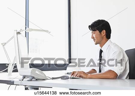 Businessman working on computer View Large Photo Image Stock Photo - Businessman working on computer. Fotosearch