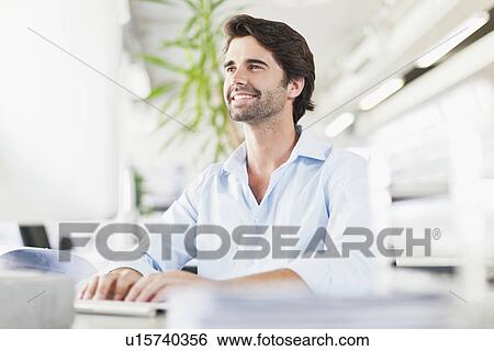 Businessman working on computer View Large Photo Image Stock Photograph - Businessman working on computer. Fotosearch