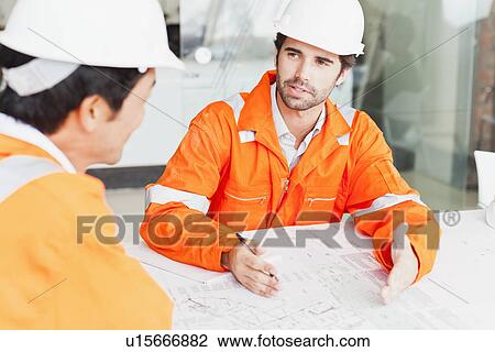 Businessmen reading blueprints View Large Photo Image Stock Image - Businessmen reading blueprints. Fotosearch