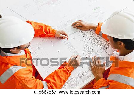Businessmen reading blueprints View Large Photo Image Stock Photo - Businessmen reading blueprints. Fotosearch