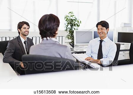 Stock Photo - Businessmen talking in office. Fotosearch