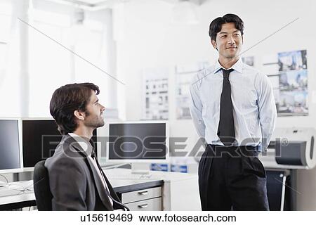 Businessmen talking in office View Large Photo Image Stock Photo - Businessmen talking in office. Fotosearch