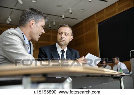 Businessmen using tablet computer at desk View Large Photo Image Stock Image - Businessmen using tablet computer at desk. Fotosearch