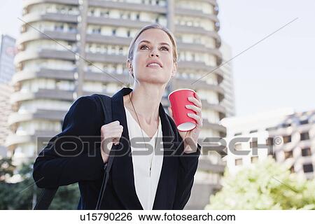 Businesswoman carrying briefcase outdoors View Large Photo Image Stock Photograph - Businesswoman carrying briefcase outdoors. Fotosearch
