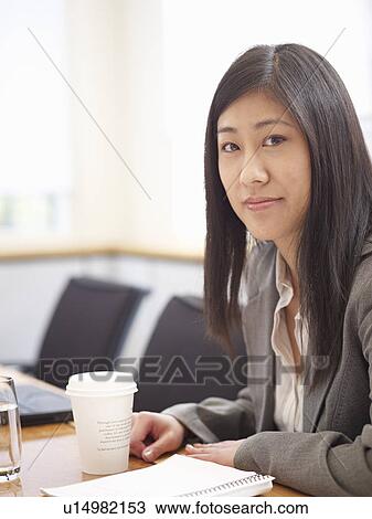 Businesswoman sitting at meeting table View Large Photo Image Stock Image - Businesswoman sitting at meeting table. Fotosearch
