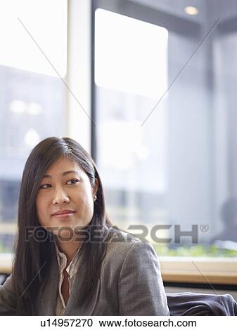 Businesswoman sitting in office View Large Photo Image Stock Image - Businesswoman sitting in office. Fotosearch