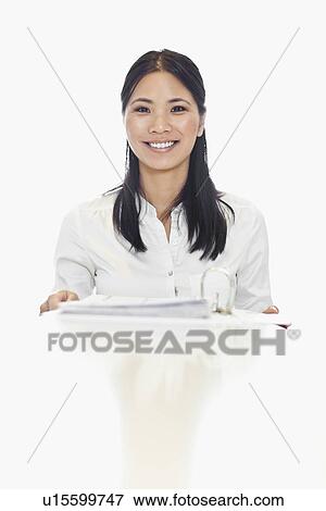 Stock Photo - Businesswoman smiling at desk. Fotosearch
