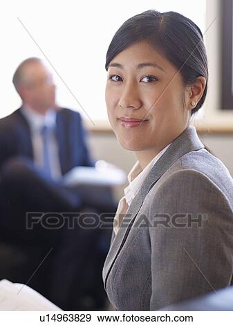 Stock Photo - Businesswoman smiling in office. Fotosearch