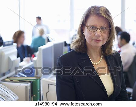 Businesswoman standing in office View Large Photo Image Picture - Businesswoman standing in office. Fotosearch