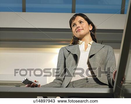 Businesswoman standing on balcony View Large Photo Image Stock Image - Businesswoman standing on balcony. Fotosearch