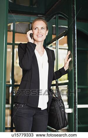 Stock Image - Businesswoman talking on cell phone. Fotosearch