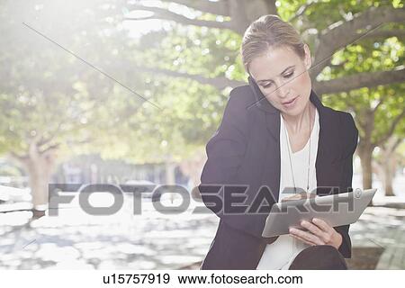 Businesswoman talking on cell phone View Large Photo Image Stock Photo - Businesswoman talking on cell phone. Fotosearch