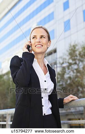 Businesswoman talking on cell phone View Large Photo Image Stock Photo - Businesswoman talking on cell phone. Fotosearch