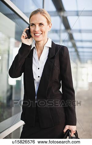 Stock Photograph - Businesswoman talking on cell phone. Fotosearch