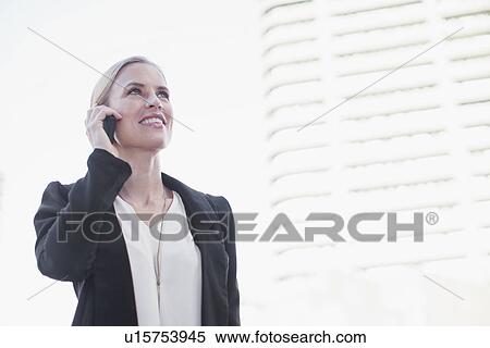 Stock Photography - Businesswoman talking on cell phone. Fotosearch