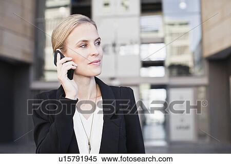 Businesswoman talking on cell phone View Large Photo Image Stock Photography - Businesswoman talking on cell phone. Fotosearch