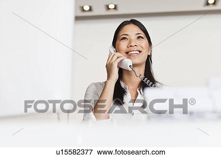 Stock Photo - Businesswoman talking on telephone. Fotosearch