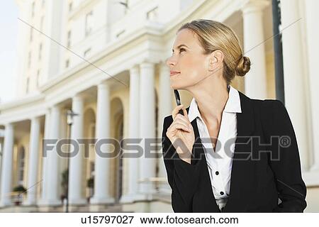 Stock Photo - Businesswoman thinking outdoors. Fotosearch