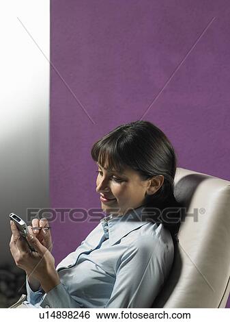 Stock Photograph - Businesswoman using cell phone. Fotosearch