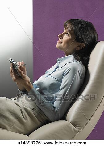 Stock Photograph - Businesswoman using cell phone. Fotosearch