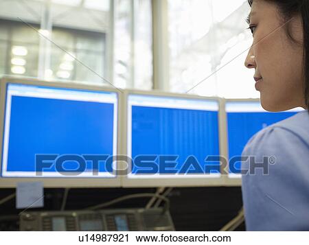 Businesswoman using computers at desk View Large Photo Image Stock Image - Businesswoman using computers at desk. Fotosearch