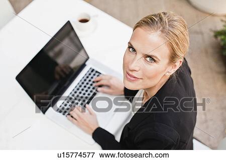 Businesswoman using laptop outdoors View Large Photo Image Stock Photo - Businesswoman using laptop outdoors. Fotosearch