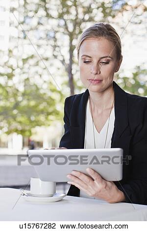 Businesswoman using tablet computer View Large Photo Image Stock Image - Businesswoman using tablet computer. Fotosearch