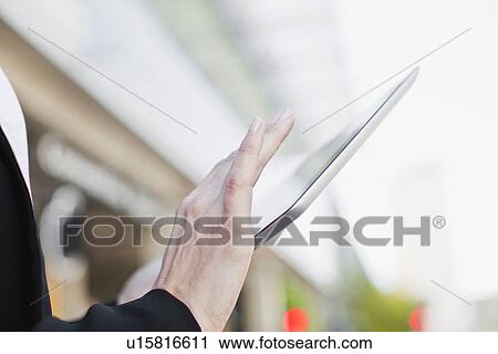 Stock Image - Businesswoman using tablet computer. Fotosearch