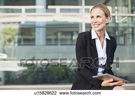 Businesswoman using tablet computer View Large Photo Image Stock Image - Businesswoman using tablet computer. Fotosearch