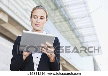 Businesswoman using tablet computer View Large Photo Image Stock Photograph - Businesswoman using tablet computer. Fotosearch